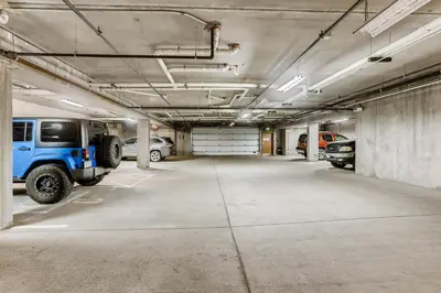 a parking garage with a blue jeep parked in it at Mount Victoria Lodge #D in Frisco