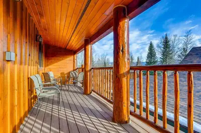 a wooden deck with chairs and tables on it at Mount Victoria Lodge #D in Frisco