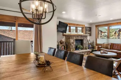 a dining room with a table and a fireplace at Mount Victoria Lodge #D in Frisco