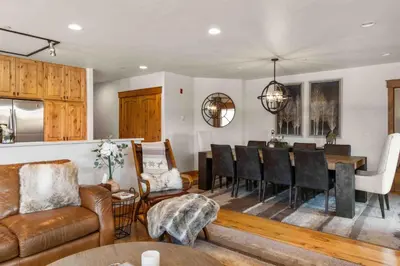 a living room with a table and a dining room at Mount Victoria Lodge #D in Frisco