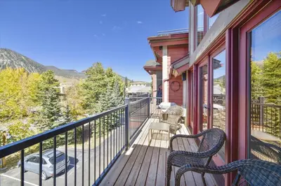 a balcony with two chairs and a view of the mountains at Marina Park 14C in Frisco