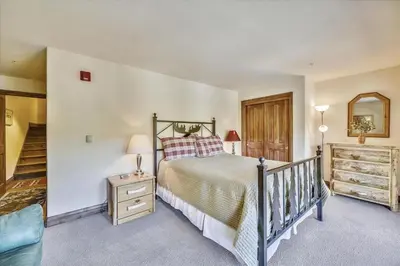 a bedroom with a bed and a dresser and a mirror at Marina Park 14C in Frisco