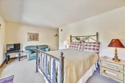 a bedroom with a bed and a desk and a television at Marina Park 14C in Frisco