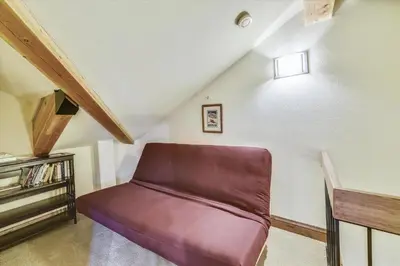 a room with a purple couch in a attic at Marina Park 14C in Frisco