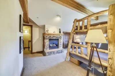 a living room with a fireplace and a bunk bed at Marina Park 14C in Frisco