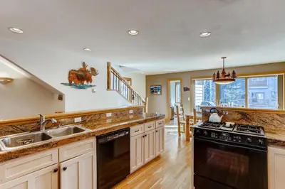 a kitchen with a sink and a stove at Streamside 333A in Frisco