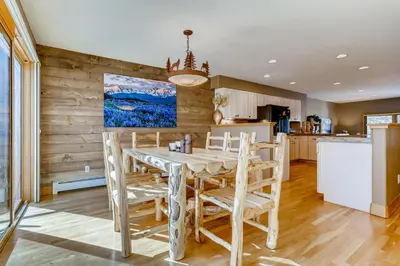 a kitchen and dining room with a table and chairs at Streamside 333A in Frisco
