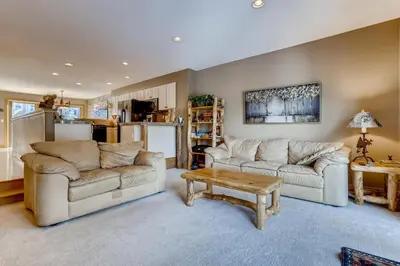 a living room with two couches and a table at Streamside 333A in Frisco