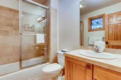 a bathroom with a toilet and a sink and a shower at Streamside 333A in Frisco