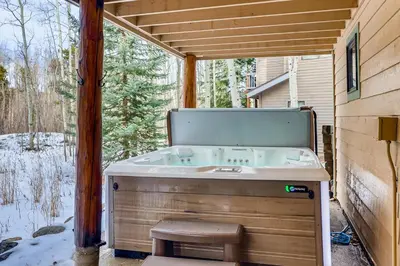 a bath tub sitting in a backyard with a window at Streamside 333A in Frisco