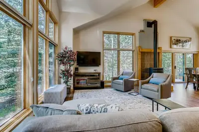 a living room with a lot of windows at Frisco Cedar Cabin in Frisco