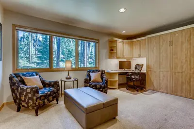 a living room with chairs and a table and a desk at Frisco Cedar Cabin in Frisco