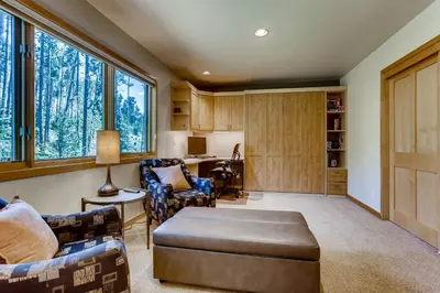 a living room with a couch and chairs and windows at Frisco Cedar Cabin in Frisco