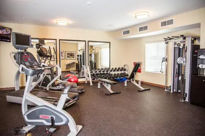 a gym with several treadmills and exercise machines at Candlewood Suites Denver North - Thornton by IHG in Thornton