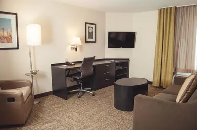 a hotel room with a desk and a computer at Candlewood Suites Denver North - Thornton by IHG in Thornton