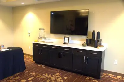 a room with a large flat screen tv on a wall at Candlewood Suites Denver North - Thornton by IHG in Thornton