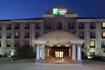 a hotel front of a building at night at Holiday Inn Express & Suites Ft Collins by IHG in Fort Collins