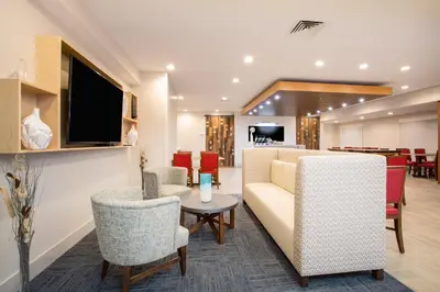 a waiting room with a couch and chairs and a table at Holiday Inn Express & Suites Ft Collins by IHG in Fort Collins