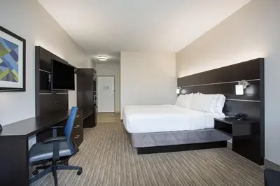 a hotel room with a bed and a desk at Holiday Inn Express & Suites Ft Collins by IHG in Fort Collins