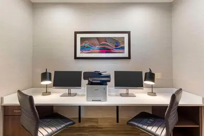 a office with a desk with two monitors and a printer at Best Western Greeley in Greeley