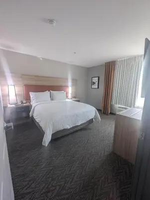 a hotel room with a large bed and a window at Candlewood Suites Loveland by IHG in Loveland
