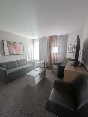 a large living room with a couch and a table at Candlewood Suites Loveland by IHG in Loveland