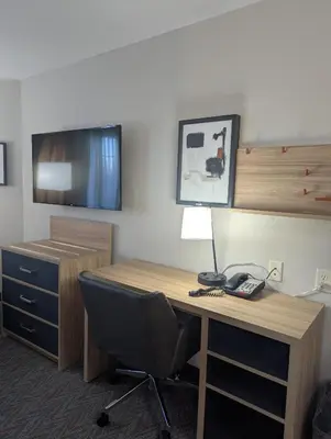 an office with a desk with a phone and a chair at Candlewood Suites Loveland by IHG in Loveland