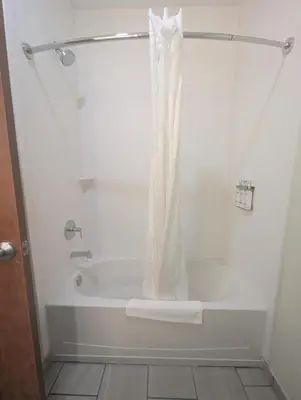 a bath tub with a shower curtain in a bathroom at Holiday Inn Express Hotel & Suites Loveland by IHG in Loveland