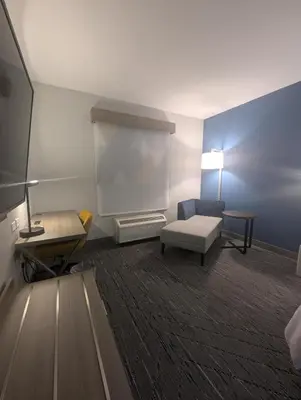 a room with a couch and a chair and a table at Holiday Inn Express Hotel & Suites Loveland by IHG in Loveland