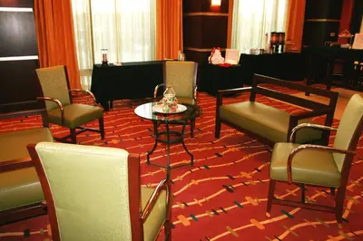 a room with chairs and a table and a piano at Hampton Inn & Suites Denver/Highlands Ranch in Littleton