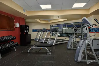 a gym with a row of treadmills and machines at Hampton Inn & Suites Denver/Highlands Ranch in Littleton