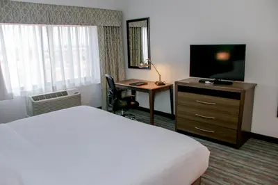 a hotel room with a bed and a television and a desk at Holiday Inn & Suites Denver Tech Center-Centennial by IHG in Centennial