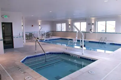 a large swimming pool in a building at Holiday Inn & Suites Denver Tech Center-Centennial by IHG in Centennial