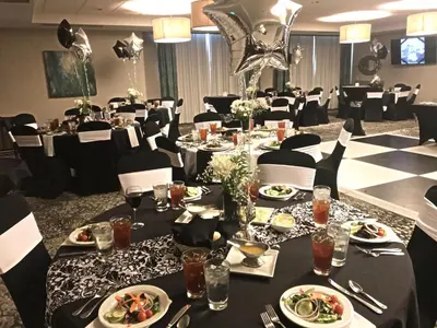 a dining room with tables and chairs with plates of food at Holiday Inn & Suites Denver Tech Center-Centennial by IHG in Centennial