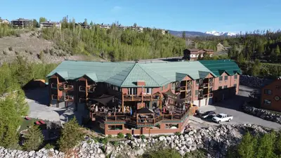 an aerial view of a large house with a green roof at Gateway Inn in Grand Lake