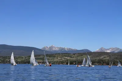 a group of sailboats on a lake with mountains at Gateway Inn in Grand Lake