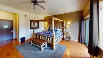 a bedroom with a bed and a ceiling fan at Gateway Inn in Grand Lake