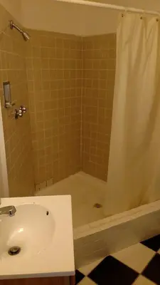 a bathroom with a tub and a sink and a shower at Essex House Motel in Littleton