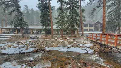 a pile of rocks and snow in front of a building at The Inn on Fall River & Fall River Cabins in Estes Park