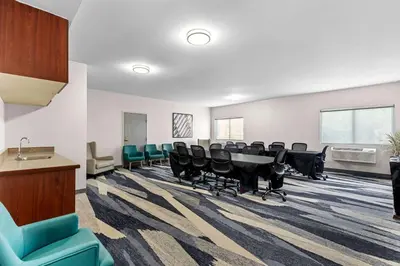 a conference room with a long table and chairs at Comfort Suites Denver North - Westminster in Westminster