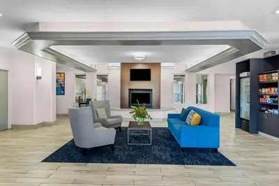 a lobby with couches and chairs and a fireplace at Comfort Suites Denver North - Westminster in Westminster