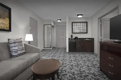 a living room with a couch and a table at Hilton Garden Inn Denver Highlands Ranch in Highlands Ranch