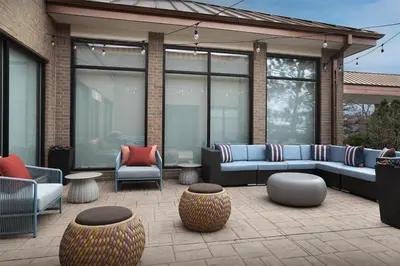 a patio with couches and chairs and tables at Hilton Garden Inn Denver Highlands Ranch in Highlands Ranch
