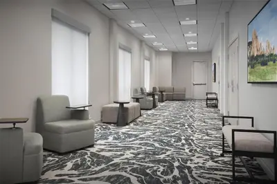 a hallway with chairs and tables in a room at Hilton Garden Inn Denver Highlands Ranch in Highlands Ranch