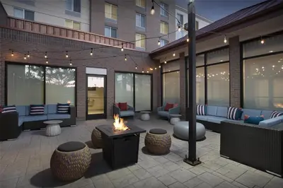 a patio with couches and a fire pit at Hilton Garden Inn Denver Highlands Ranch in Highlands Ranch