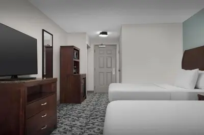 a hotel room with a bed and a flat screen tv at Hilton Garden Inn Denver Highlands Ranch in Highlands Ranch