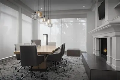 a dining room with a table and chairs and a fireplace at Hilton Garden Inn Denver Highlands Ranch in Highlands Ranch