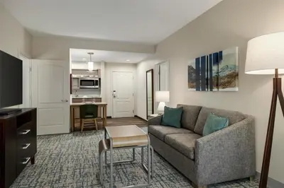 a living room with a couch and a table at Homewood Suites by Hilton Denver West - Lakewood in Lakewood