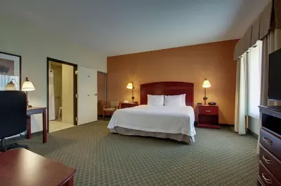 a hotel room with a bed and a desk at Hampton Inn & Suites Denver Littleton in Littleton