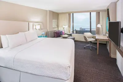 a hotel room with a large bed and a desk at Sonesta Denver Downtown in Denver